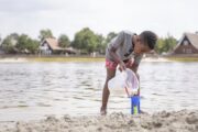 Spelen aan het water bij het zwemmeer op Hof van Saksen