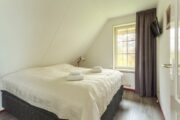 Slaapkamer onder het schuine dak