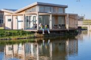 Terras met mensen bij een water villa in Zeeland