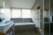 Badkamer met ligbad en inloopdouche