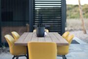 Modern tuinmeubilair met gele stoeltjes